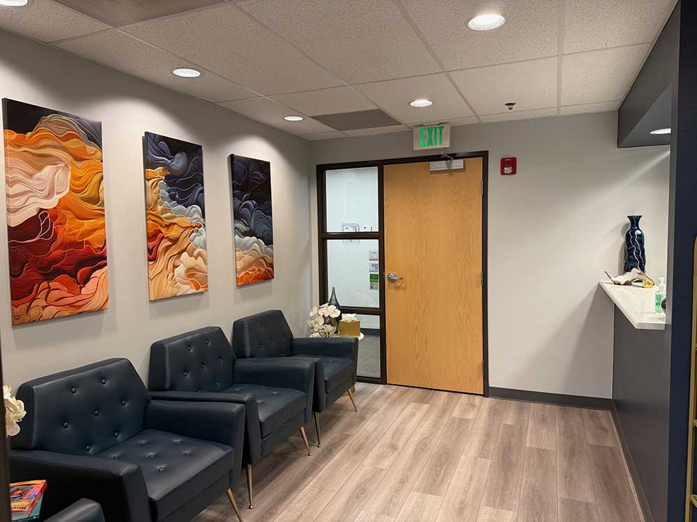 Reception area at Mountainview Periodontics with seating and framed artwork