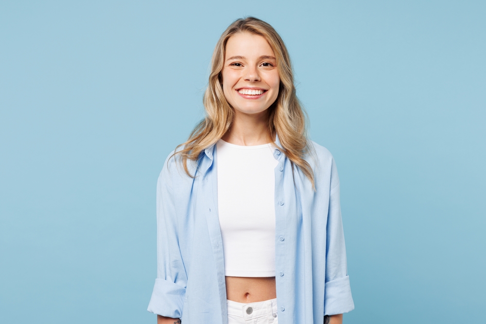 A smiling young woman, healthy and happy after a biopsy at Mountainview Periodontics